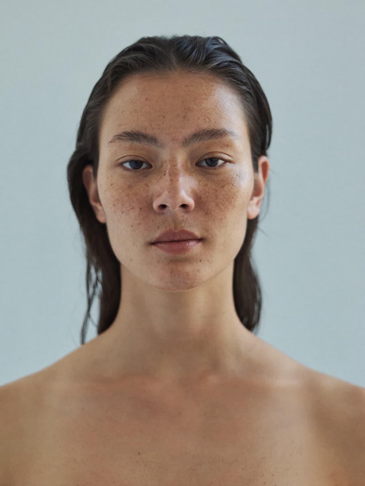 Portrait of a woman with natural, freckled skin